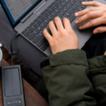 A man transfers files to a disk from a laptop