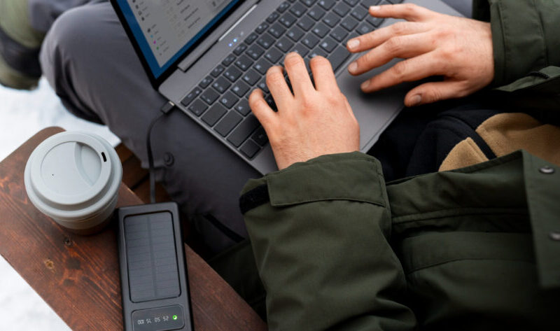 A man transfers files to a disk from a laptop