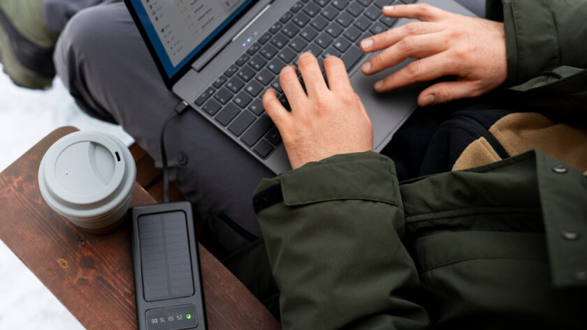 A man transfers files to a disk from a laptop